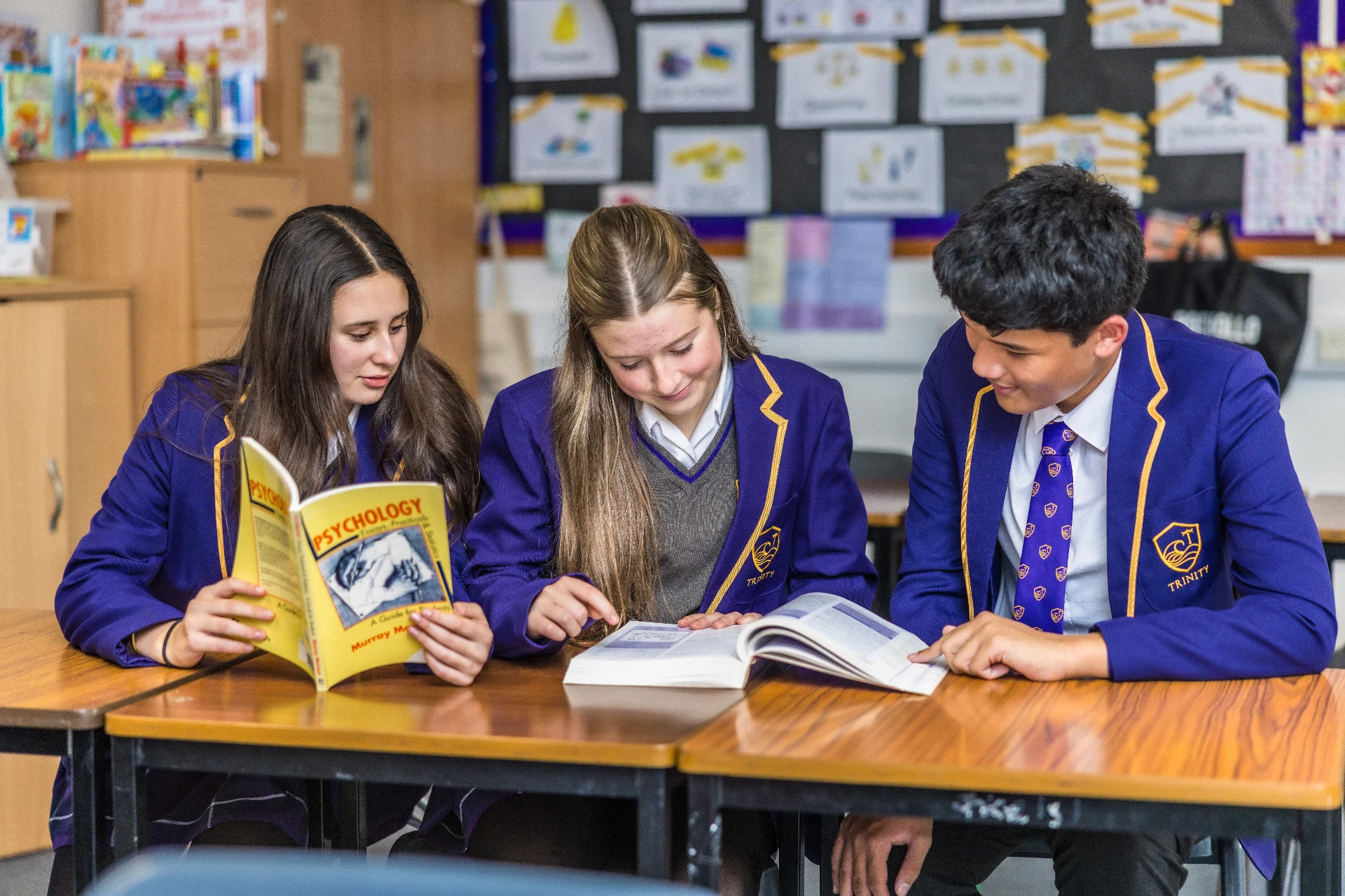 Trinity Senior School pupils studying together with textbooks in a classroom